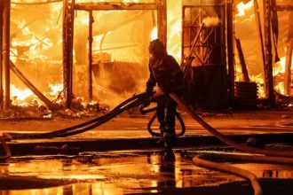 firefighter works at a site of a book market