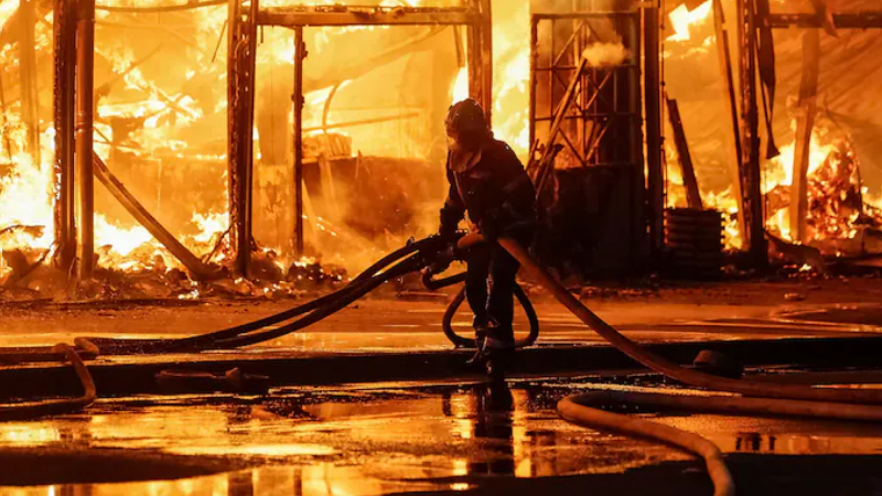 firefighter works at a site of a book market
